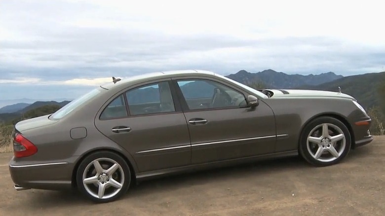 Metallic brown Mercedes-Benz E550 parked near the edge of a hill