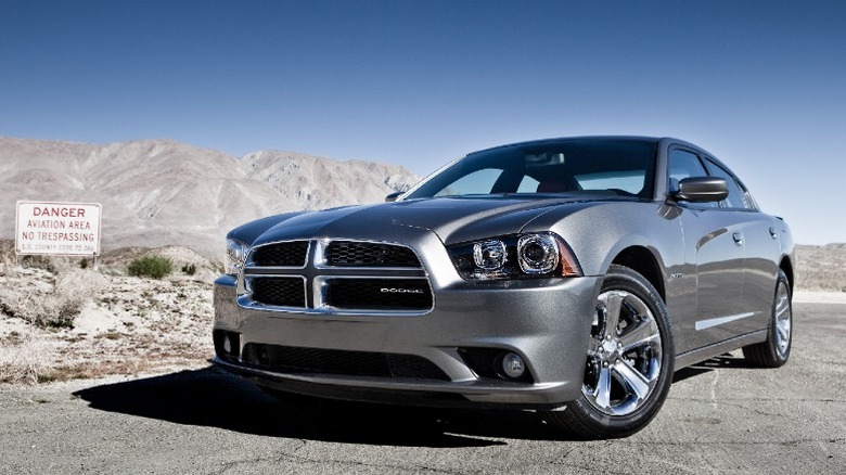 Shiny grey Dodge Charger on a dry desert road