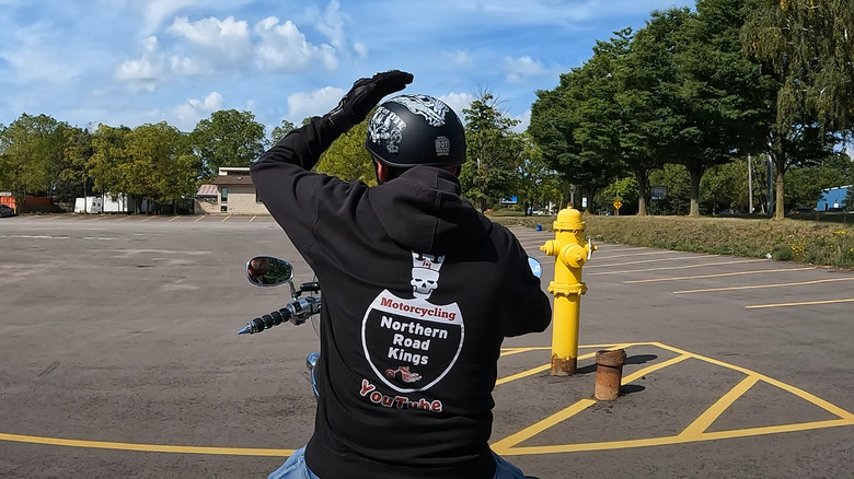 A biker in full fear showing us the police ahead hand signal