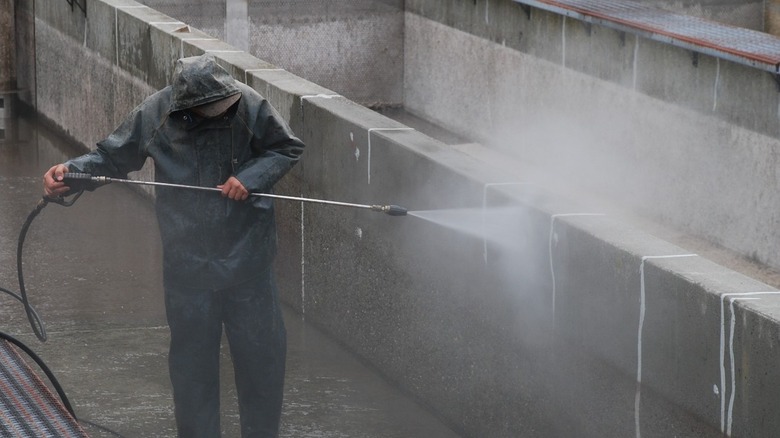 Power Washer cleaning a wall with water