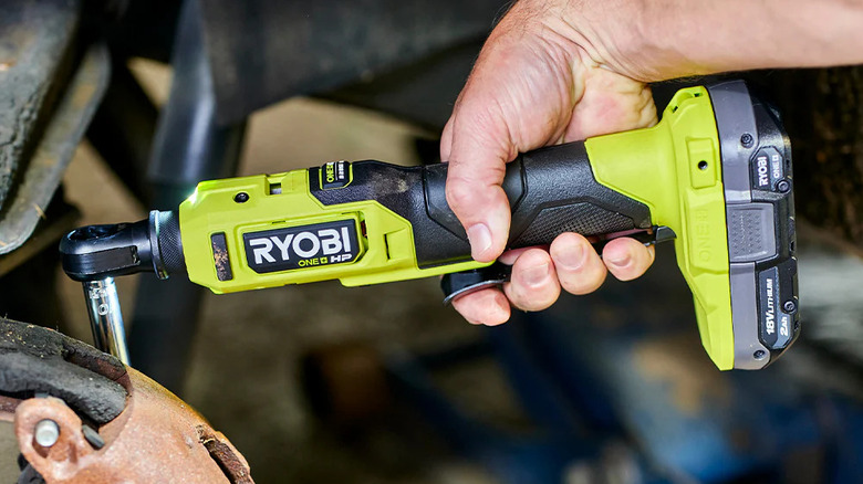 person using cordless ratchet on brake caliper