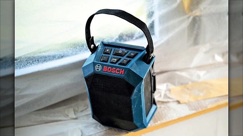 Compact Bosch jobsite speaker placed along a window.
