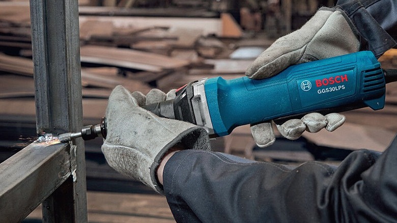 Using a die grinder to work with fasteners.