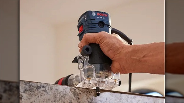 Using a laminate trim router on edges of a surface.