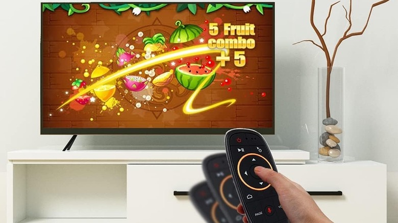 A TV with an air mouse in front of it, controlling the cursor