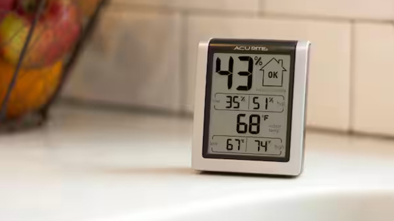 Acurite digital humidity monitor on a kitchen countertop