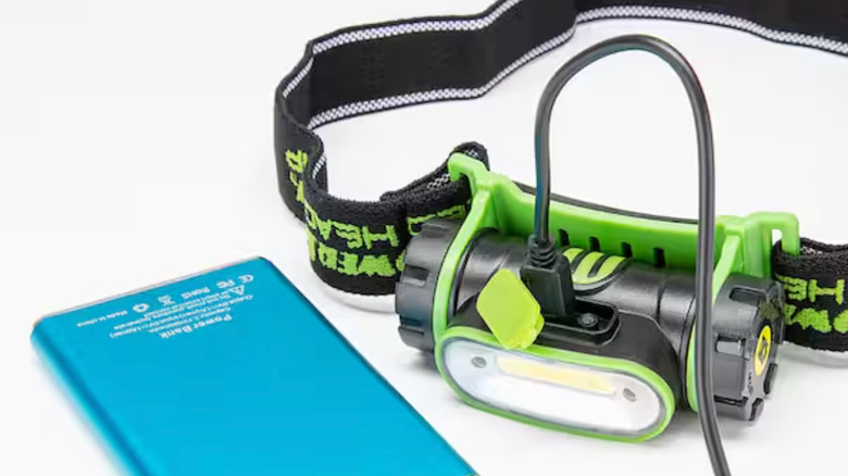 A headlamp connected to a power bank for charging