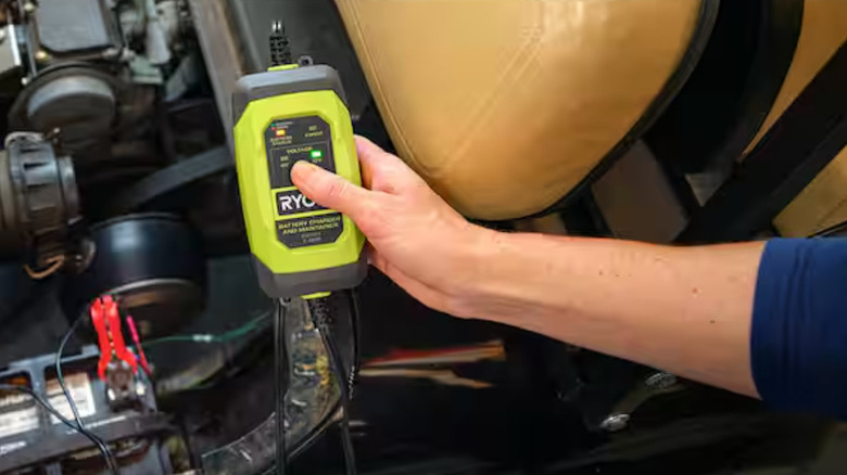 A Ryobi battery charger jump starting a vehicle battery