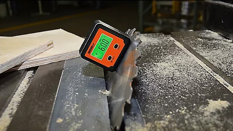 Using a digital angle locator to assess angle of the work surface.