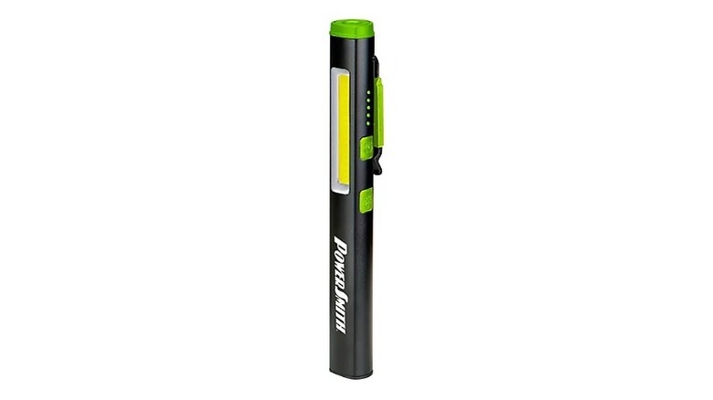 A small, black and green pen light against a white background.
