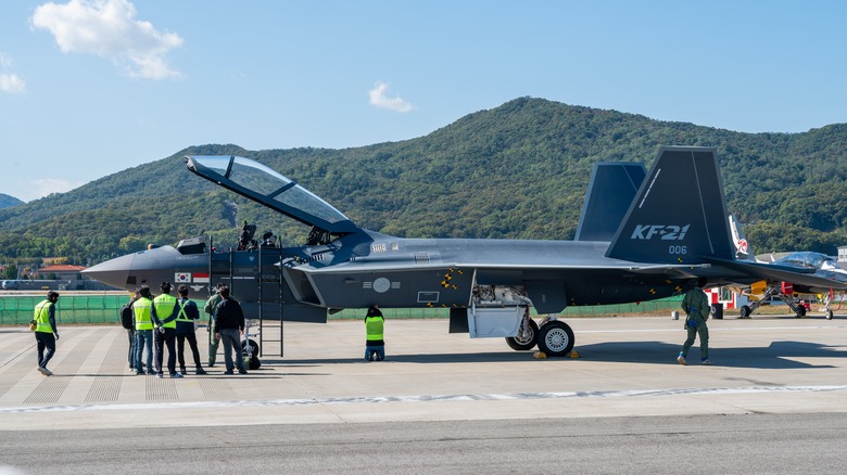 A Korean KF-21 Boramae displayed on the ground with cockpit open at a military show