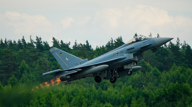 A German Air Force Eurofighter Typhoon taking off in the evening