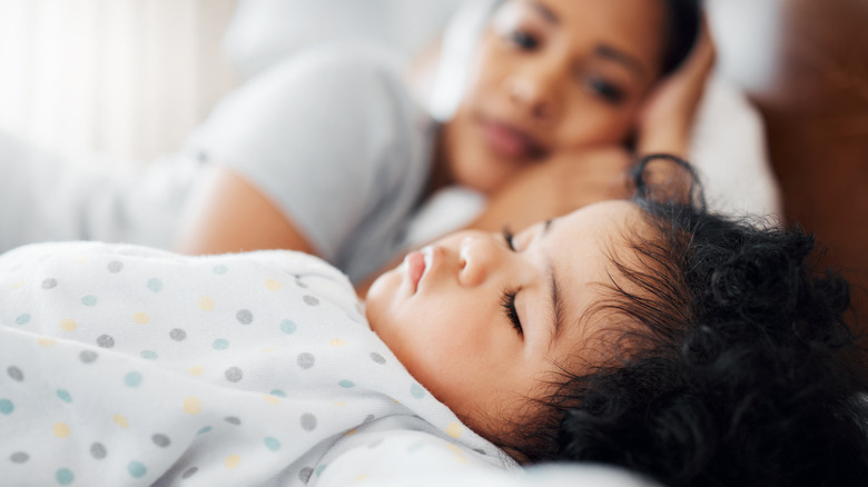 Mother laying down with child for a nap