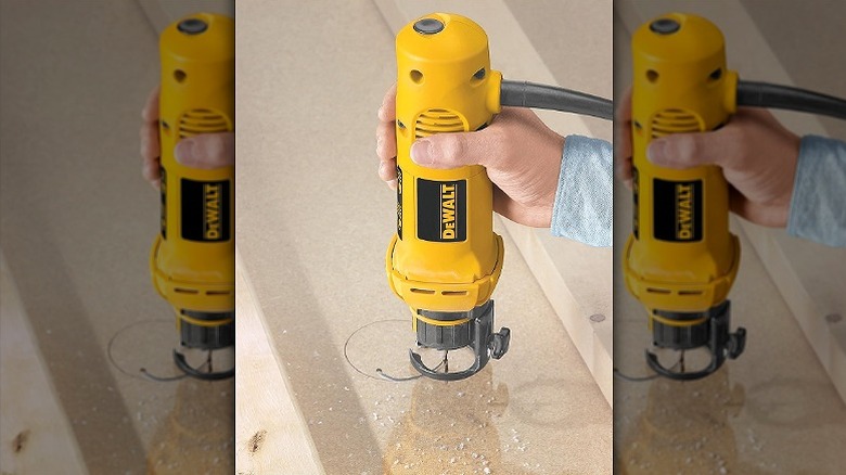 Using rotary saw on a wooden surface.