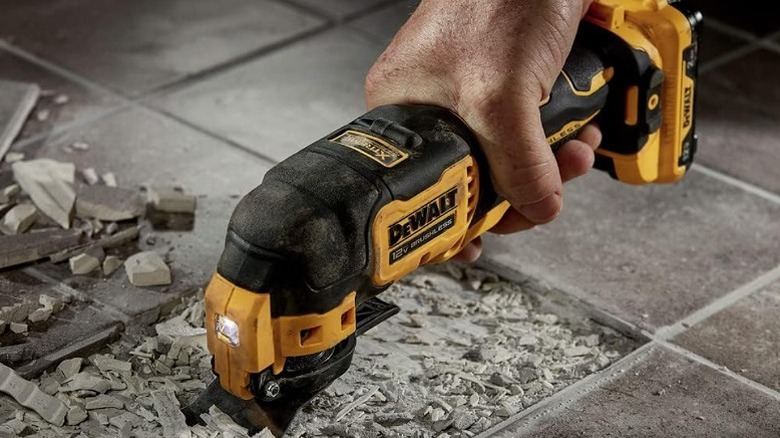 Using an oscillating tool to crush tiles.