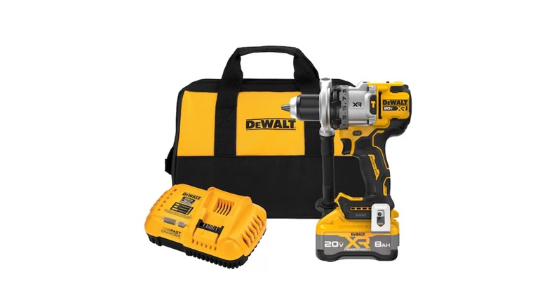 DeWalt kit of hammer drill, batteries, charger, and bag, on a white background