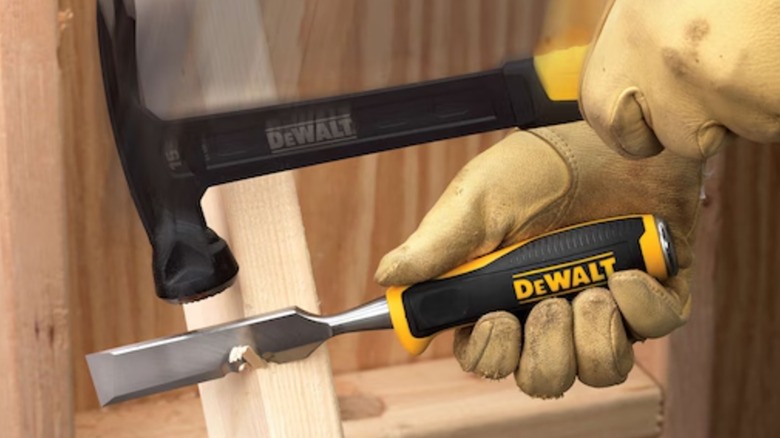 A DeWalt chisel being struck by a hammer