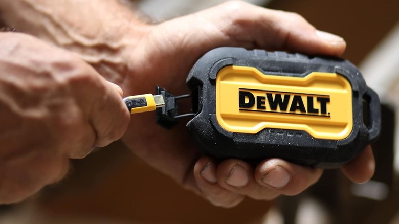 person plugging USB-C cable into DeWalt Power Bank
