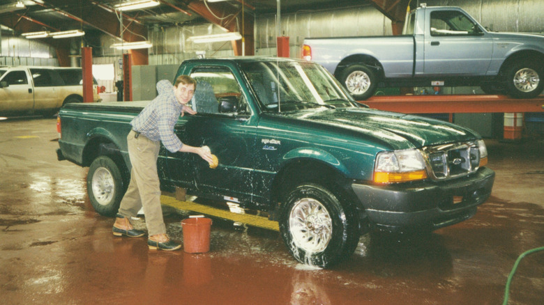 Ford Engineer and Wash Boy Daniel Schumann cleaning a Ford Ranger EV at Ford Testing Center in Minnesota circa 1996