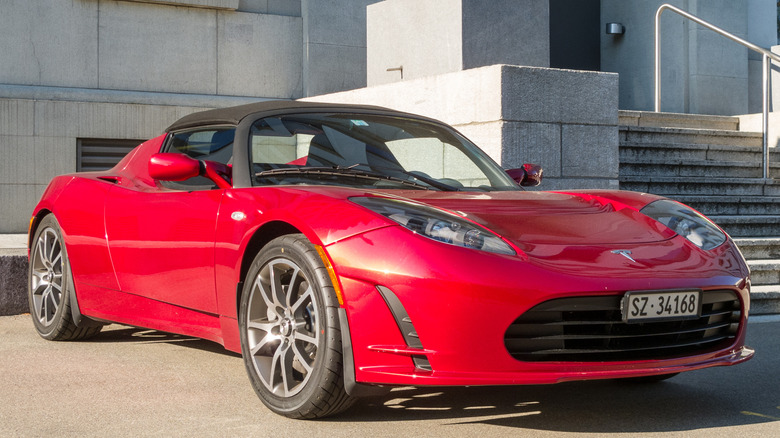 Red Tesla Roadster in a parking lot