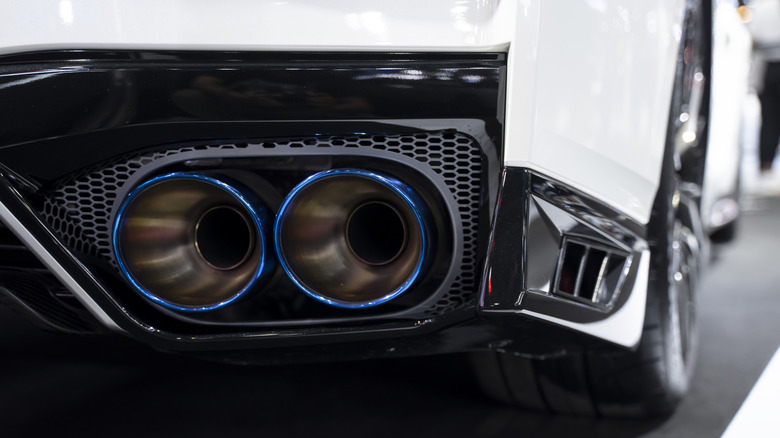A close up view of a fancy exhaust system on a passenger car