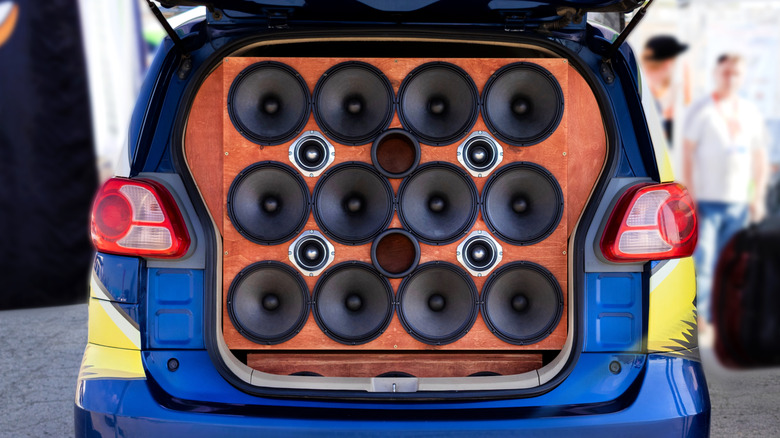 A ridiculous amount of speakers and tweeters mounted to the boot of a hatchback car