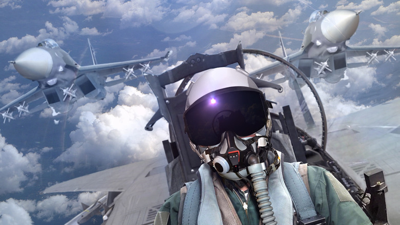 fighter jet pilot in cockpit with jets over both wings