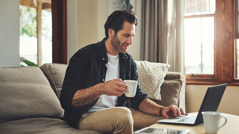 A person working from home with a coffee and laptop