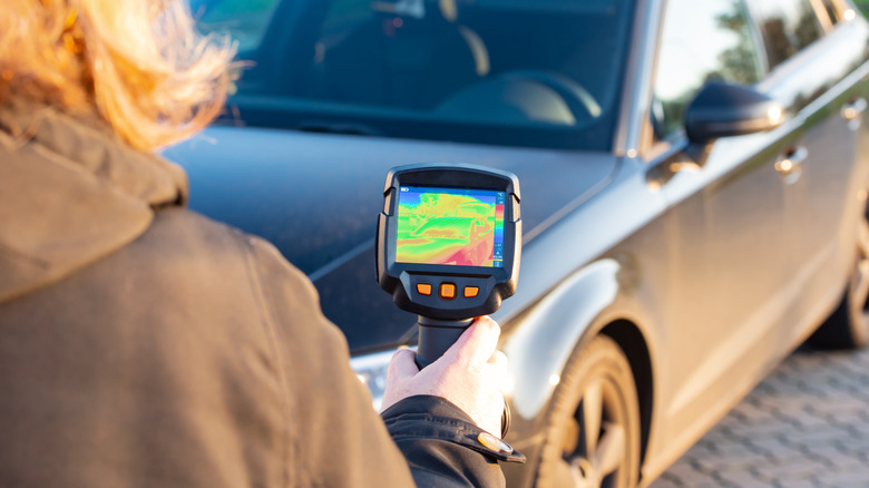 Thermal image device pointing at car