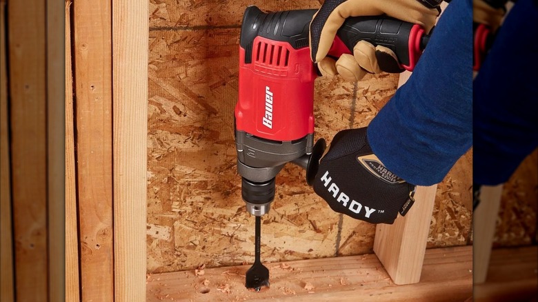 drilling into timber wall frame with Bauer hammer drill