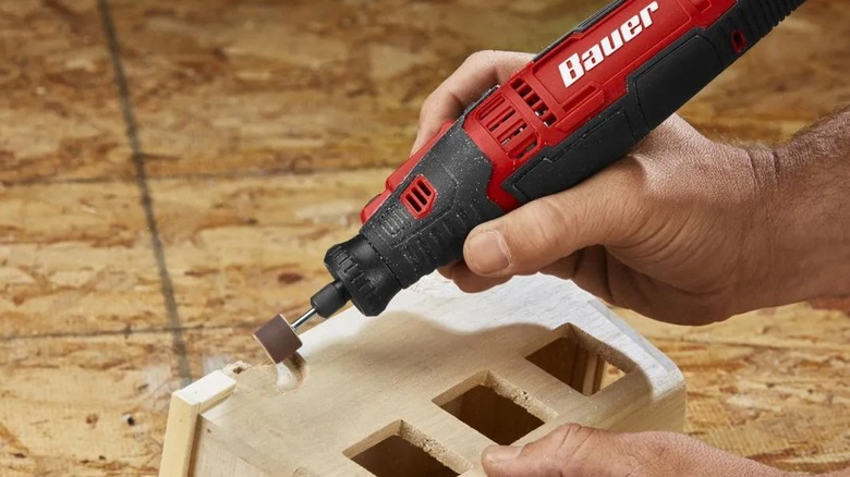 shaping detailed section of a wooden box with Bauer rotary tool