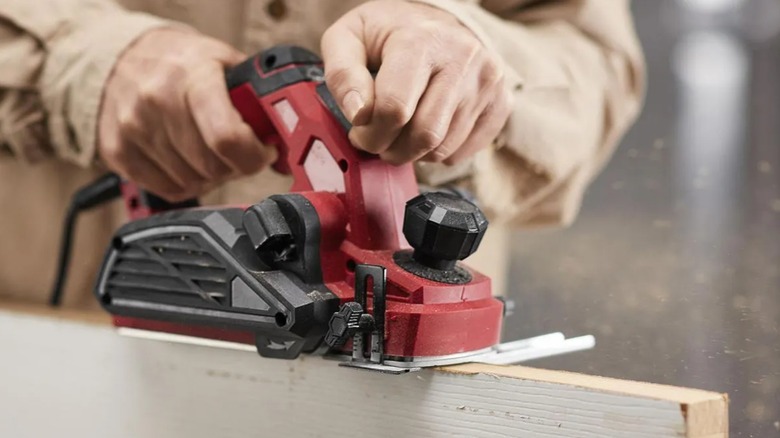 planing side of door with electric planer