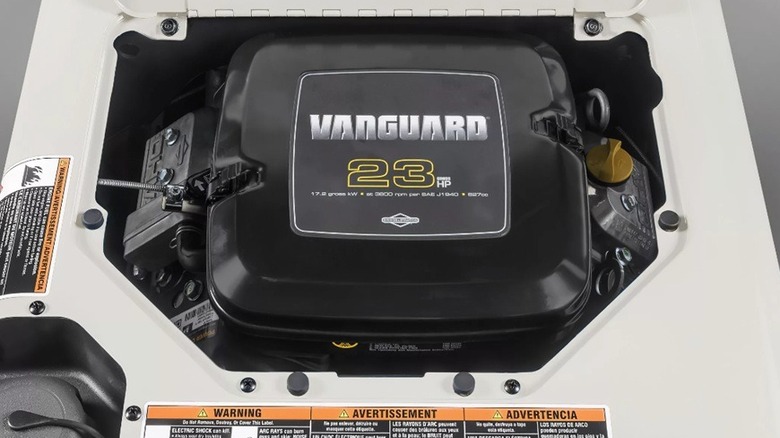 Close up of welder with open panel showing engine