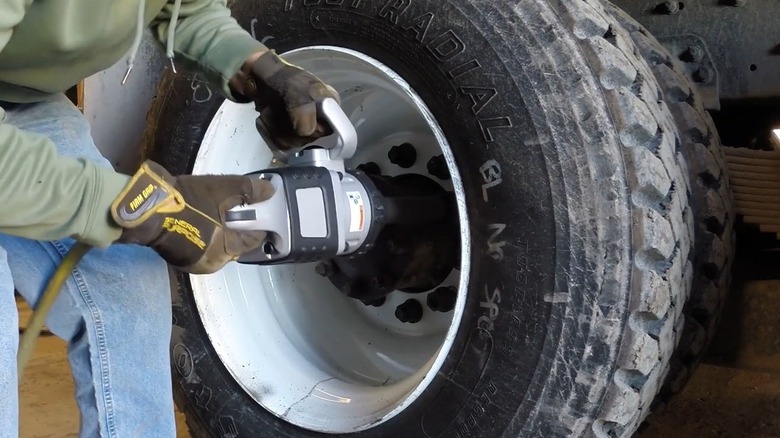 Person using Ingersoll Rand impact wrench