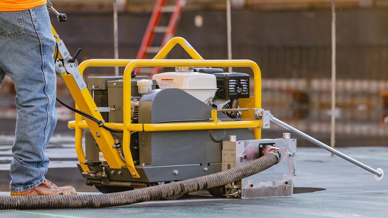 Person using Tomahawk concrete saw