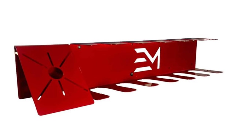 An unofficial bright red steel M18 tool organizer with slots for drills, batteries, and chargers.