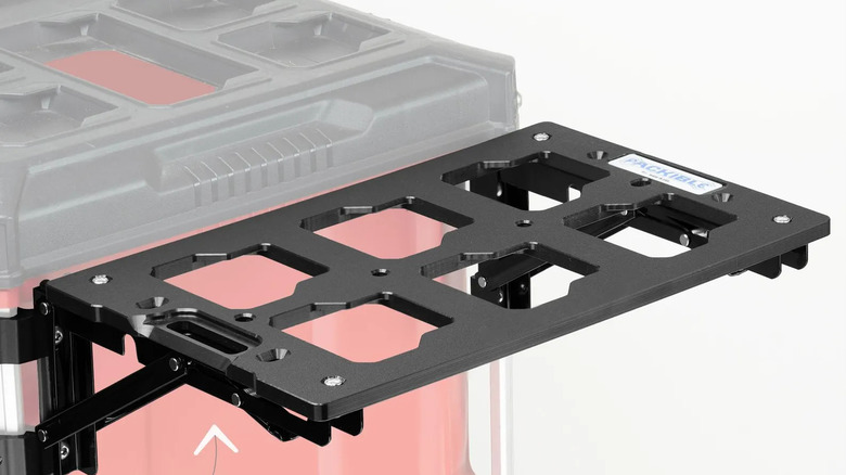 A black folding bracket mounted on the side of a Milwaukee Packout box.