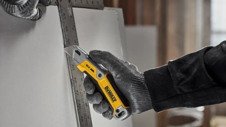 cutting drywall with DeWalt knife