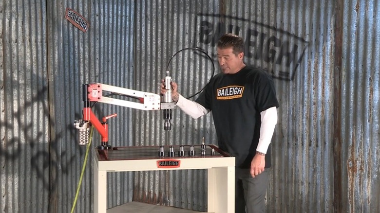 Baileigh employee showcasing tapping arm