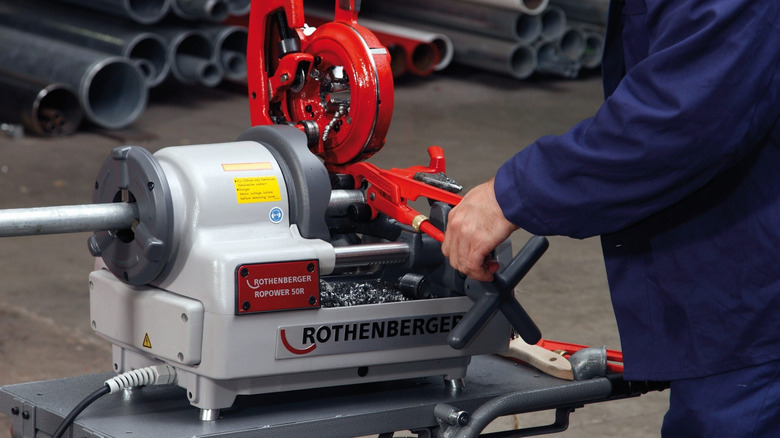 Person using Rothenberger tube cutter