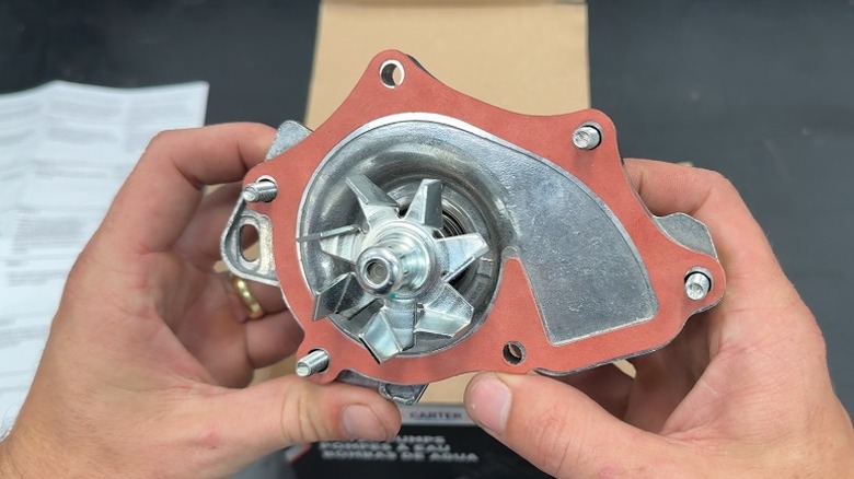 Man holding a Carter rapid fit water pump.