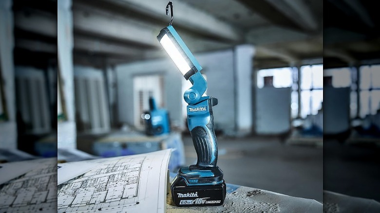 A Makita flashlight used in a construction site to read designs.