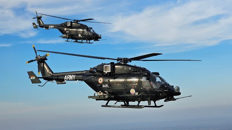 Two Indian Army HAL Rudra helicopters hovering against a blue sky