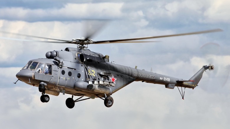 Russian Mil Mi-17 helicopter hovering against a cloudy sky