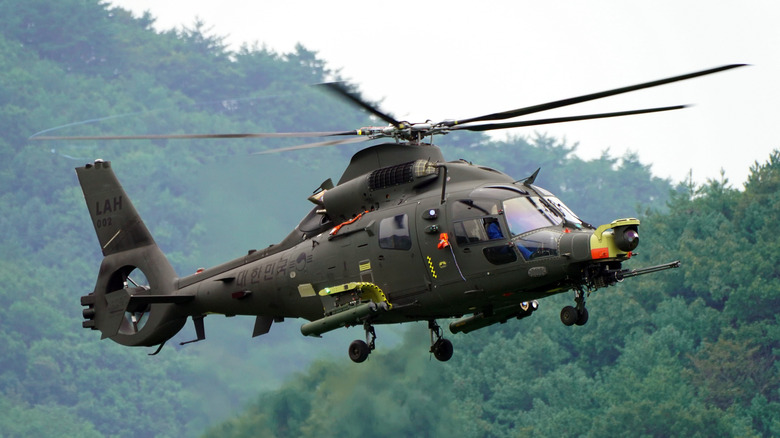 Korean Light Attack Helicopter prototype hovering in a forested area
