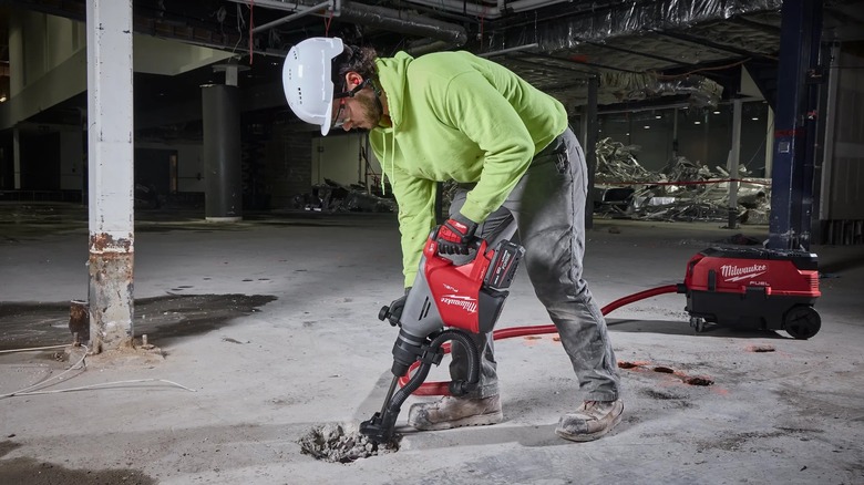 breaking up concrete flooring with demolition hammer