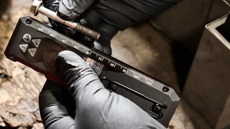 measuring a part with the side of the flat flashlight