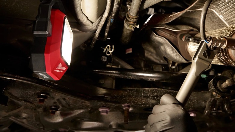using task light under a car to access a part