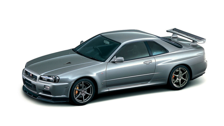 Nissan Skyline GT-R R34 front 3/4 view on white background