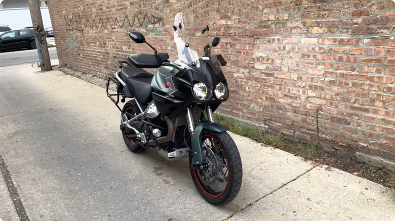 A 2014 Moto Guzzi Stelvio 1200 NTX adventure motorcycle parked on a city street.